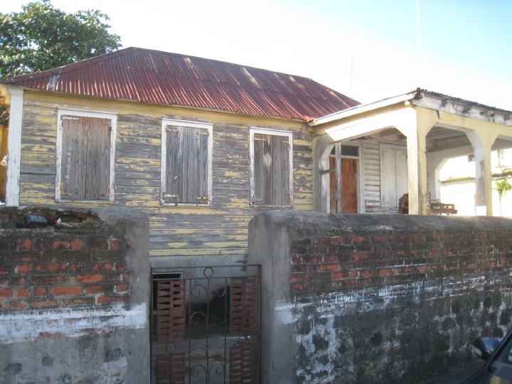 an old clap-board house where Tony once lived