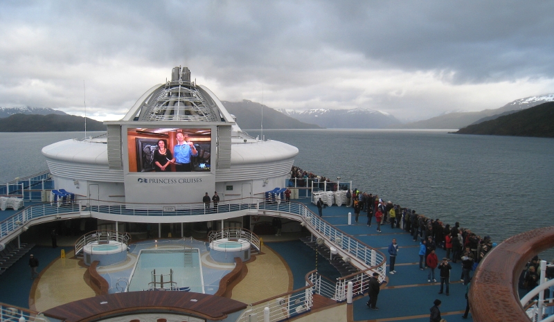 jumbotron of the Star Princess cruise ship, with snow-capped mountains in the background