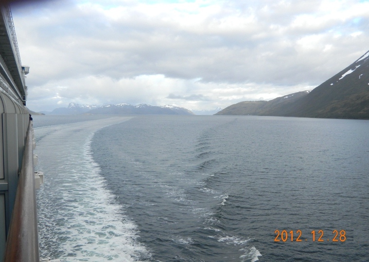 looking back at the ship's wake, while the mountains and glaciers of the Beagle Channel are all around.